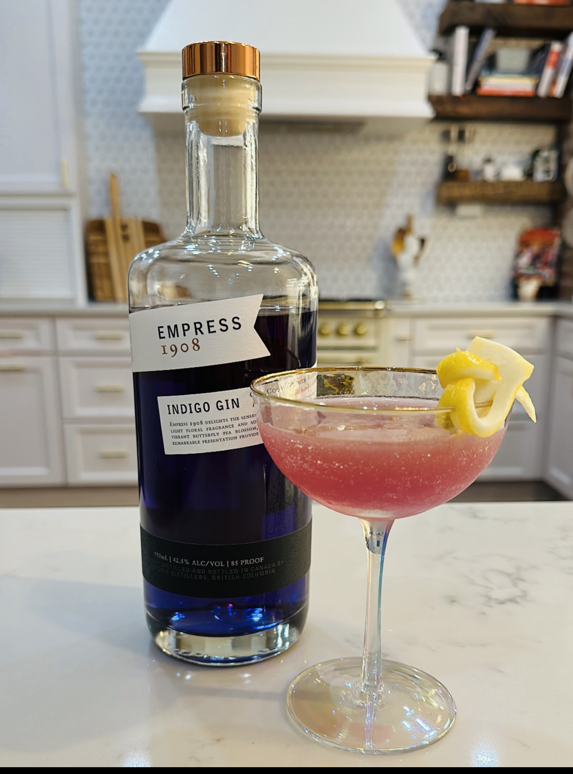 Easy Summer Gin cocktail with gin, agave syrup, and fresh lemon juice in coupe glass with a lemon twist