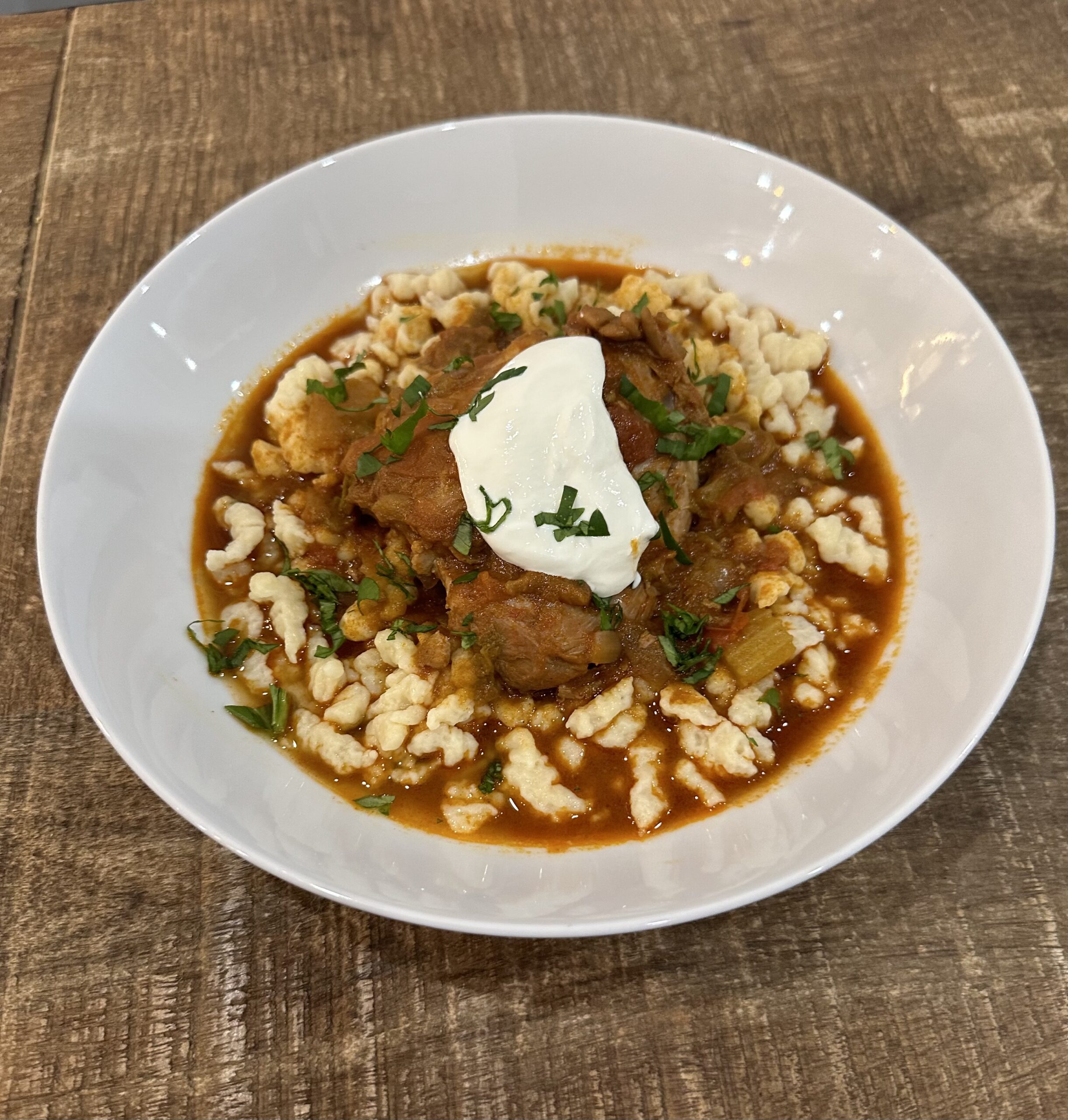 Bowl of Hungarian chicken paprikash with homemade spaetzle