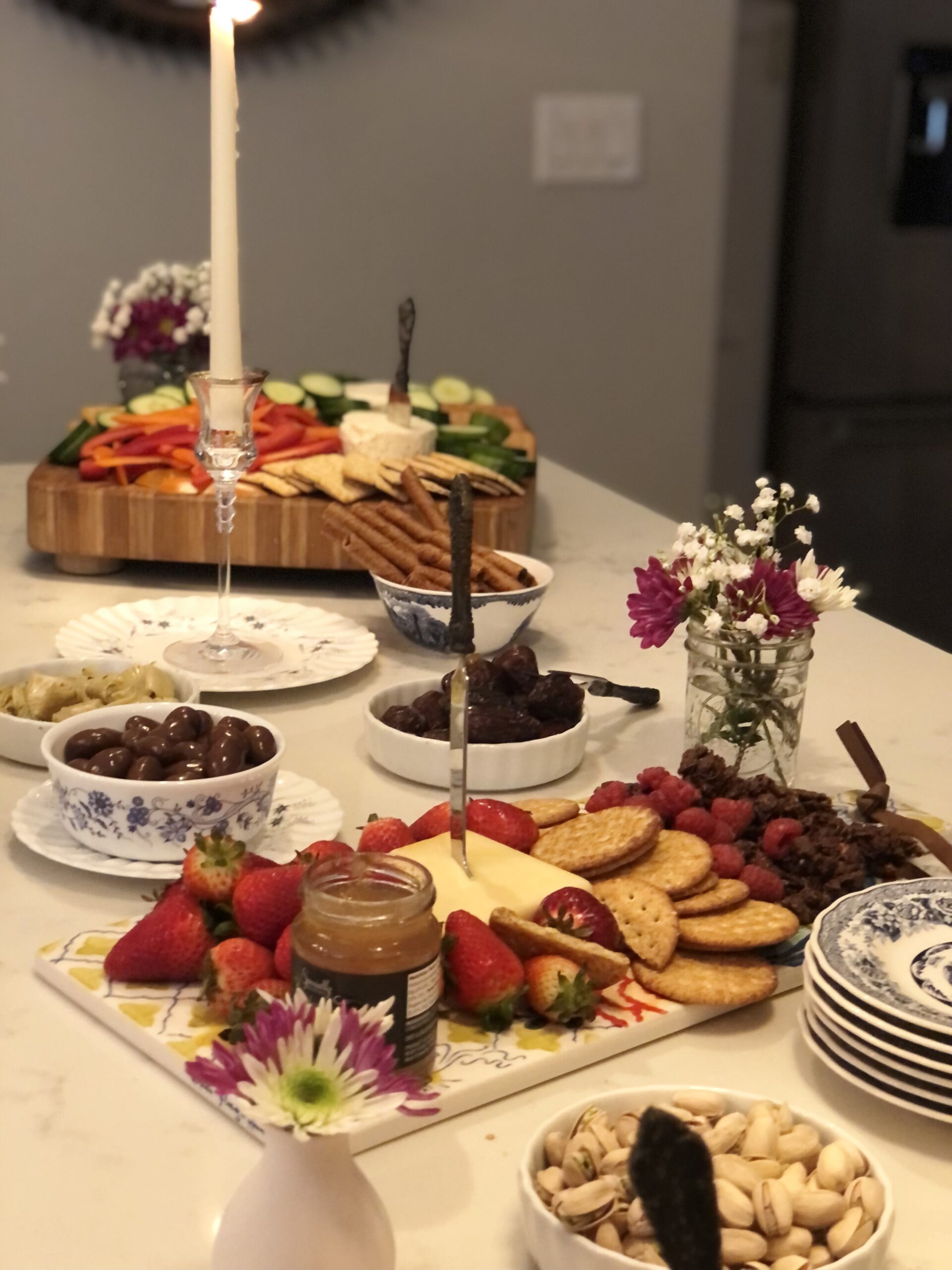 charcuterie display with candles and flowers