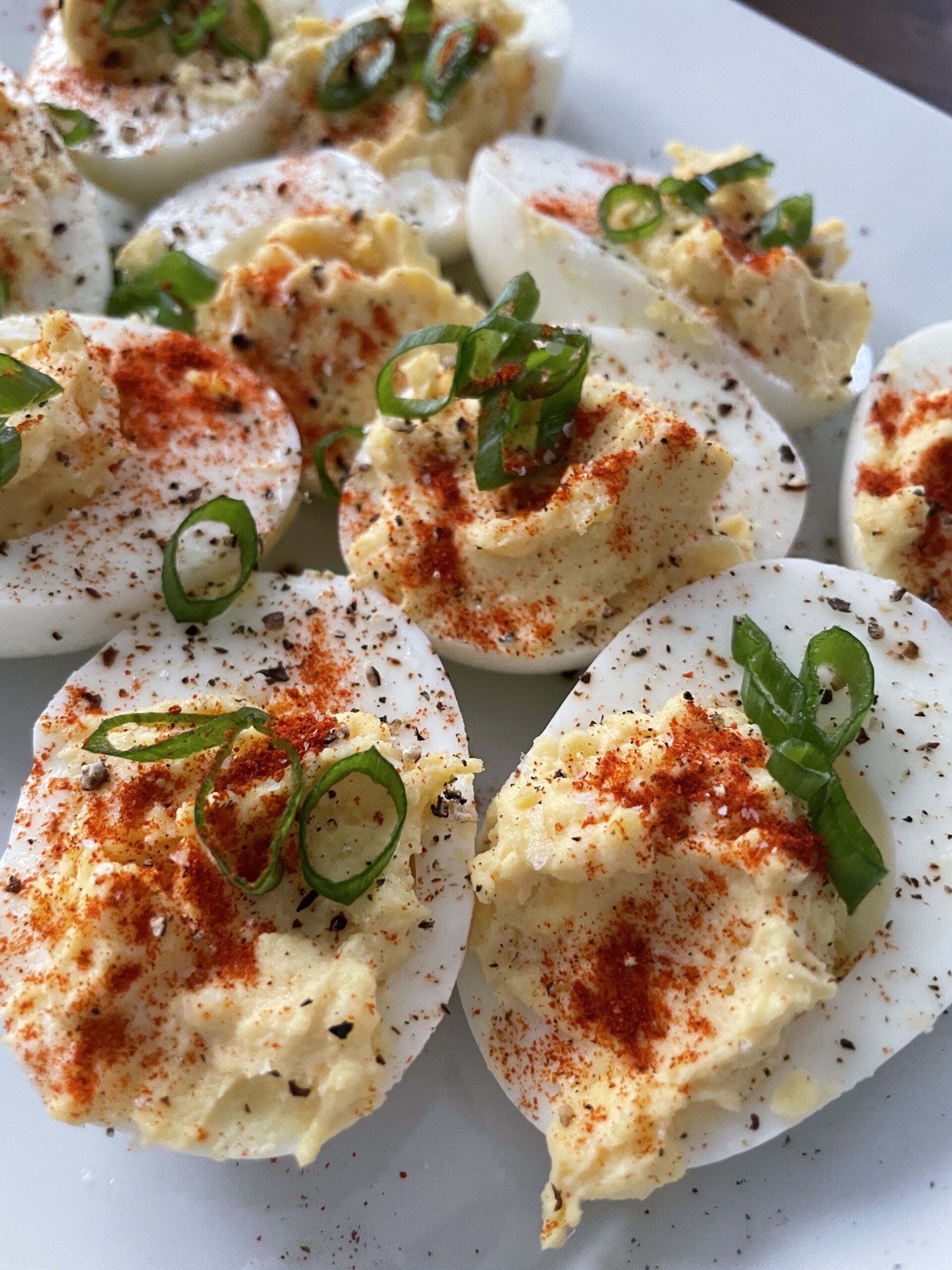 deviled eggs with paprika and green onions