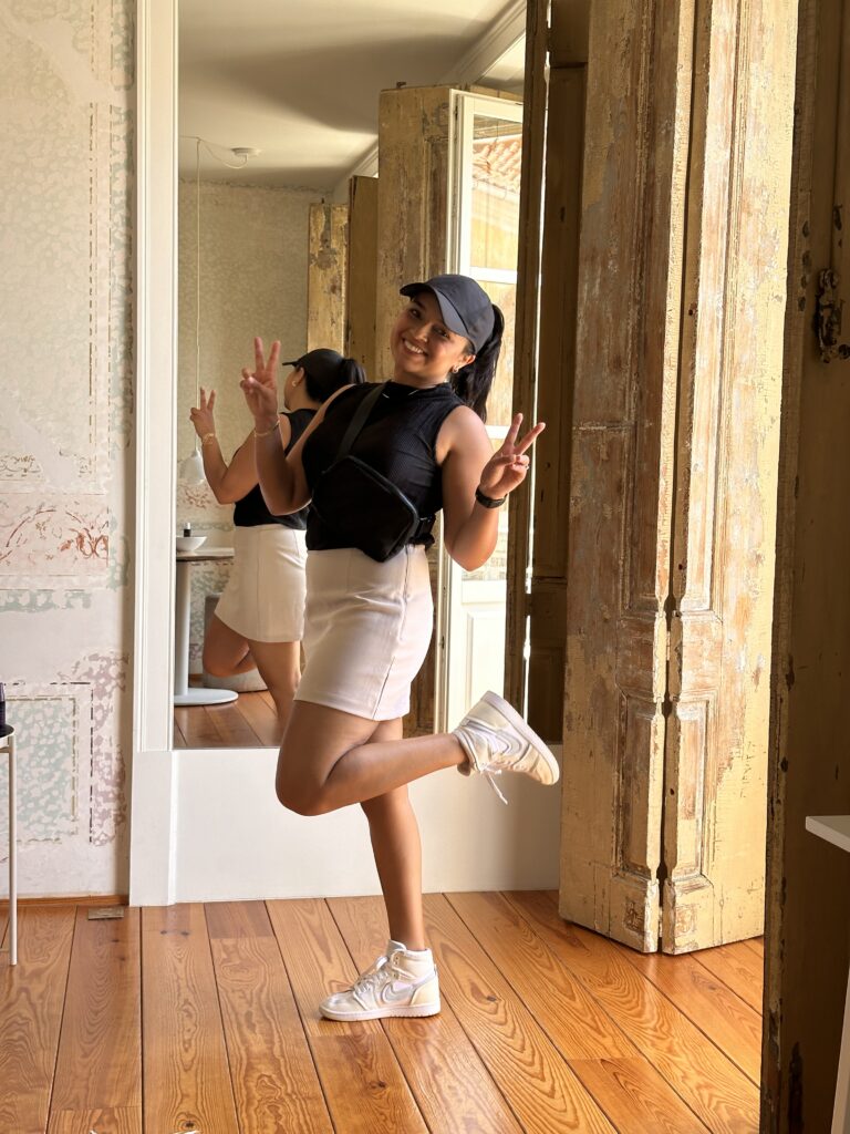 outfit packed in carry-on nikes, skort, sleeveless top, hat and purse