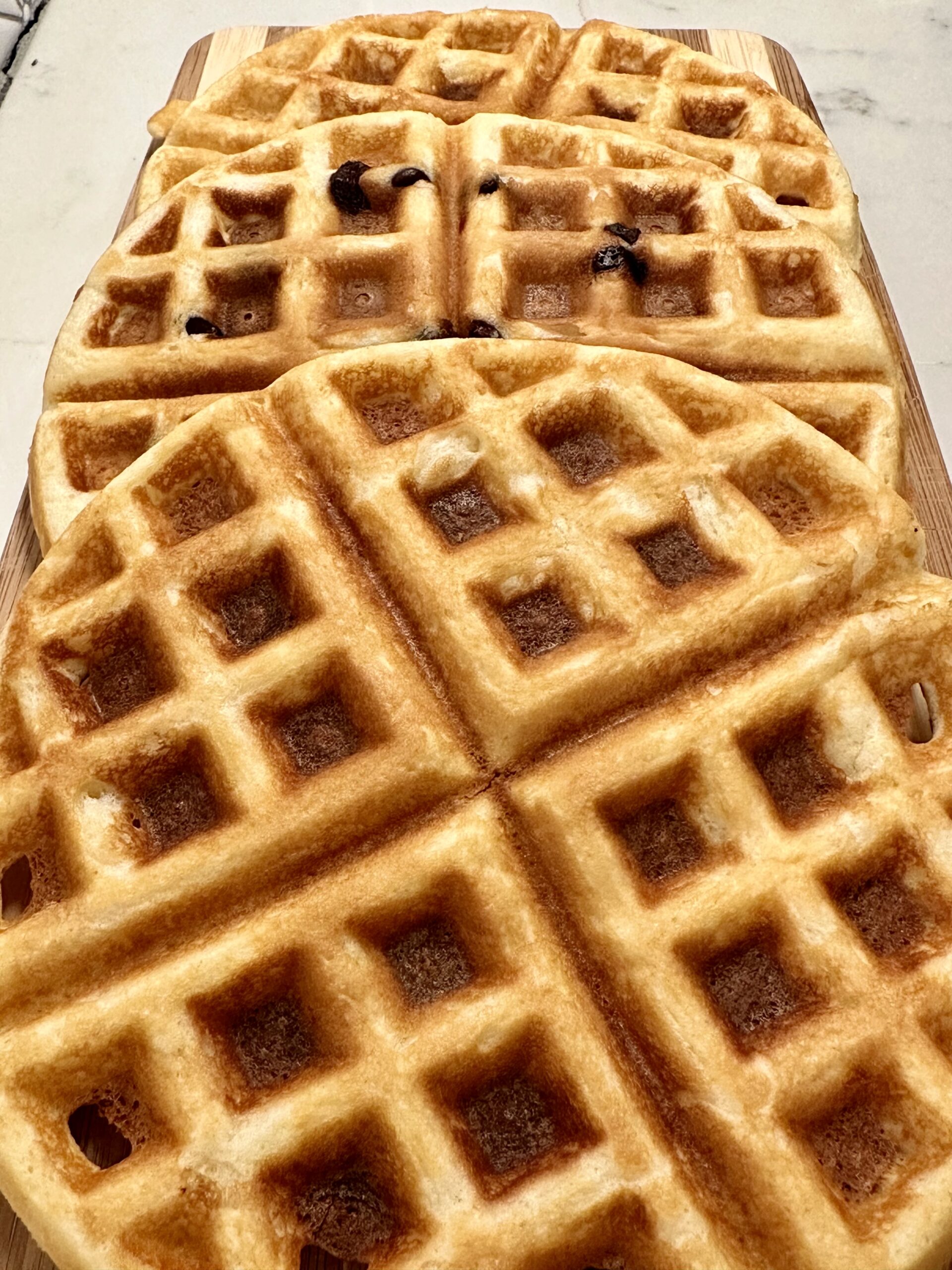 three fluffy and crispy waffles on a plate